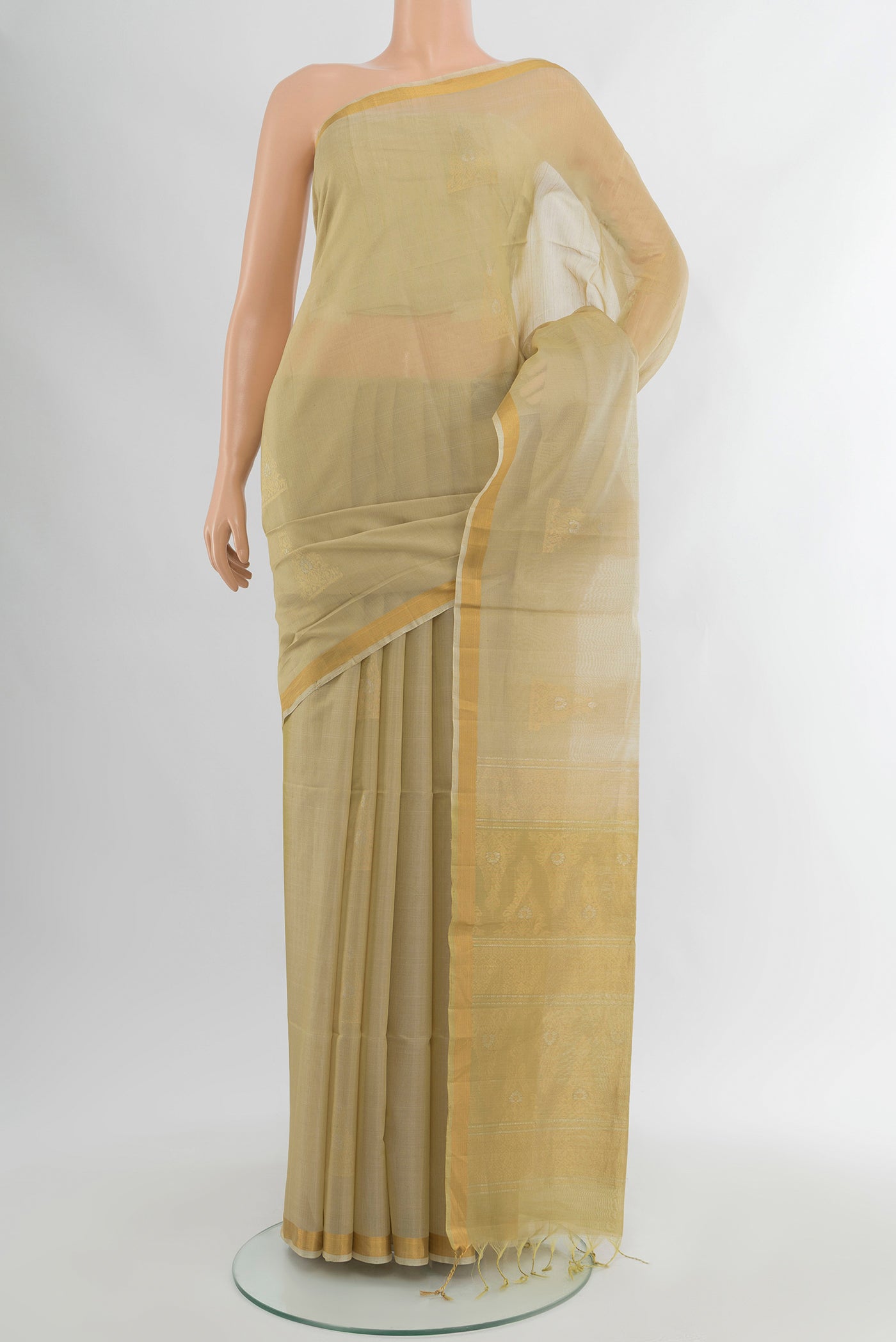 Beige Silk Cotton Saree with Zari Butta on the body and Zari Border.  displayed on a mannequin
