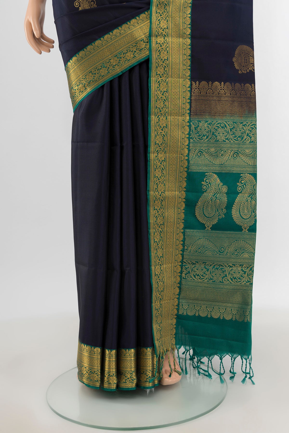 Pleats and pallu of Navy Blue Soft Silk Saree with Zari Butta on the body and Zari Border. 