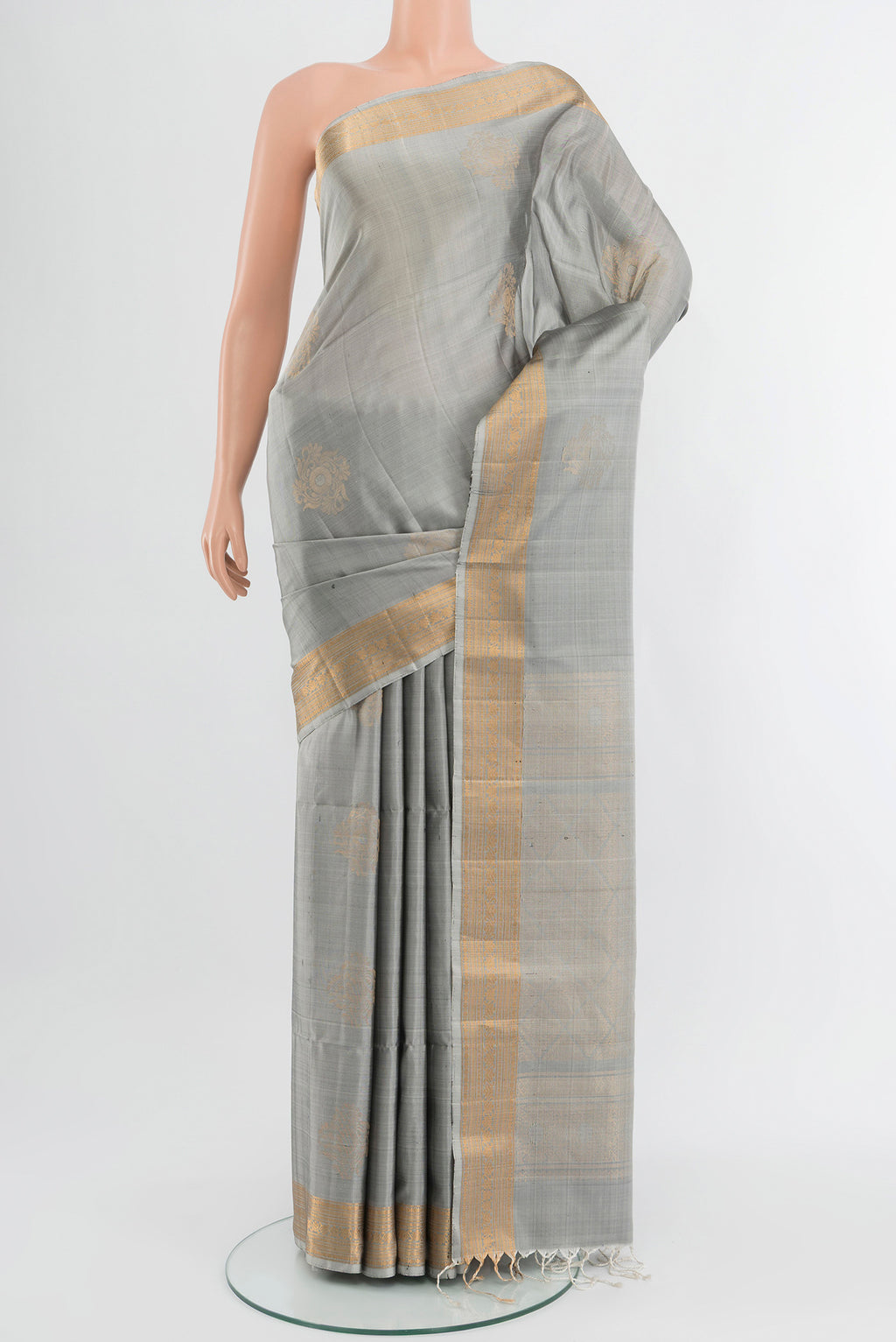 Davys Grey Soft Silk Saree with Zari Butta on the body and Zari Border.  displayed on a mannequin