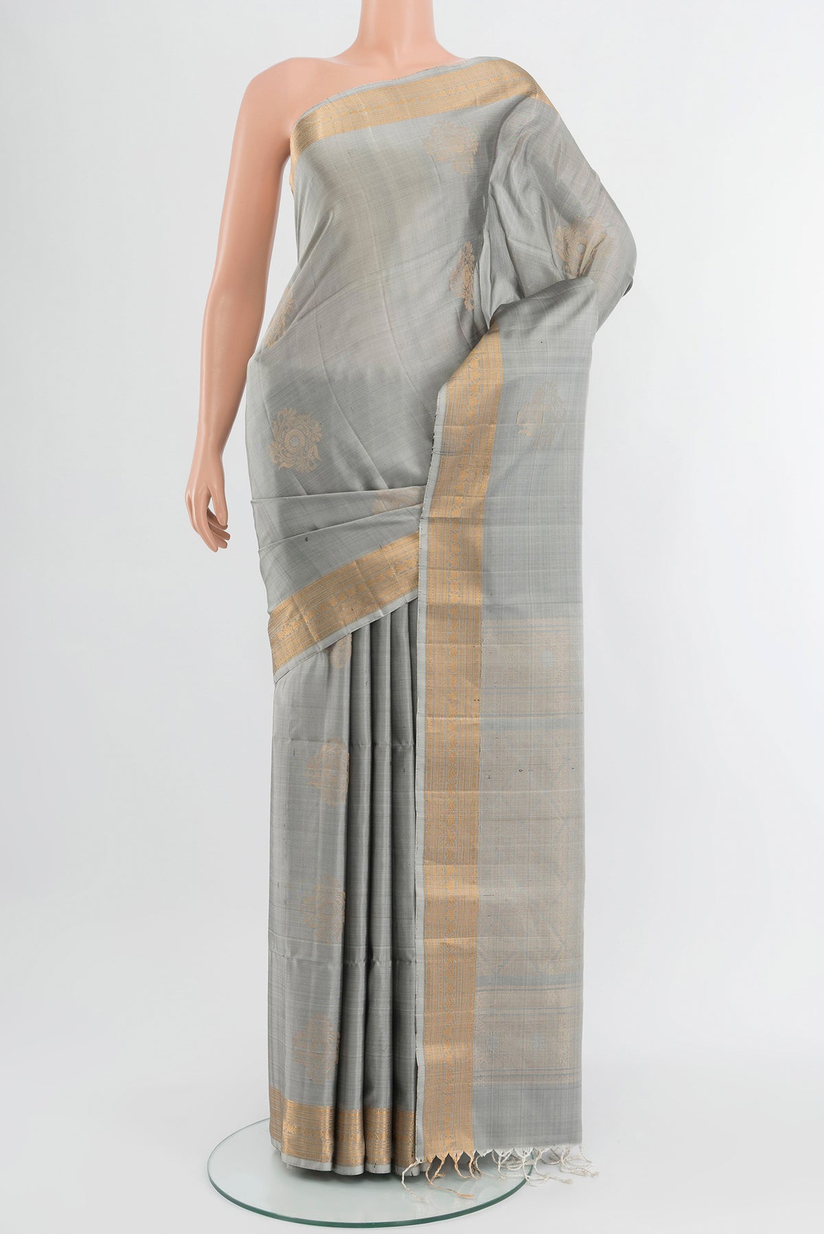 Davys Grey Soft Silk Saree with Zari Butta on the body and Zari Border.  displayed on a mannequin