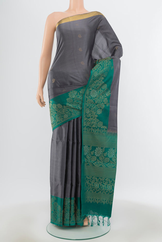 Pure Silk Pure Zari Davys Grey Soft Saree with Zari Butta on the body and Silk Border.  displayed on a mannequin