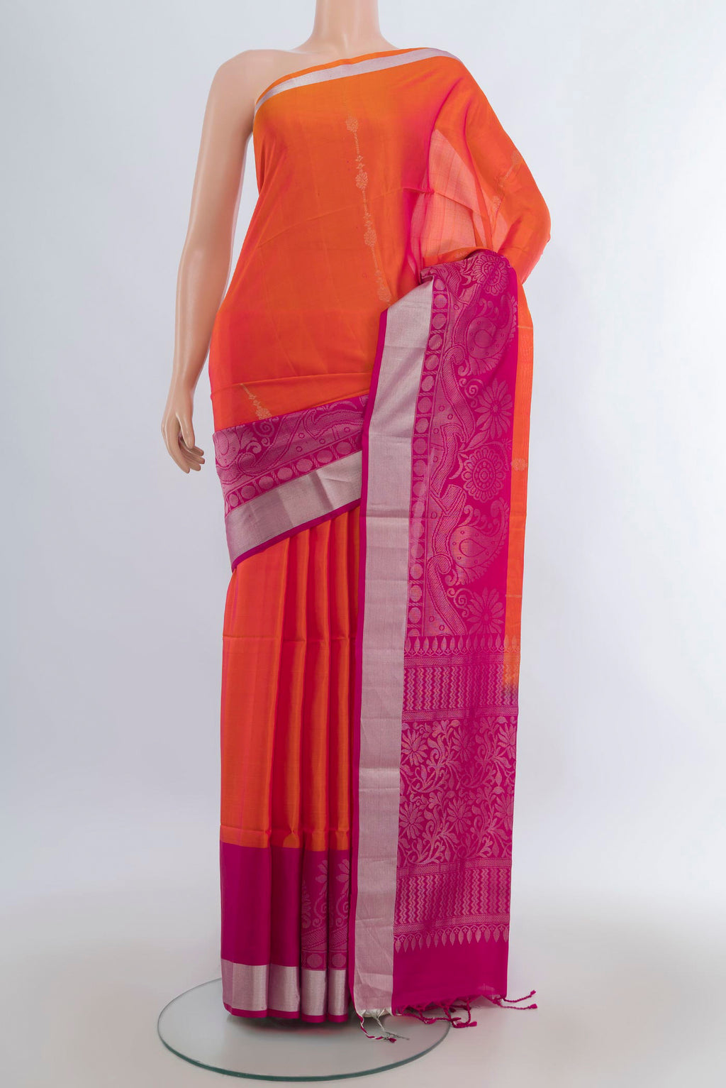 Pure Silk Brick Orange Soft Saree with Zari Butta on the body and Zari Border.  displayed on a mannequin