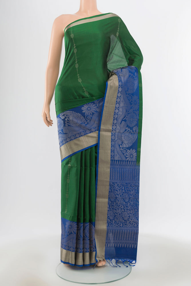 Pure Silk Pure Zari Bottle Green Soft Saree with Zari Butta on the body and Silk Border.  displayed on a mannequin