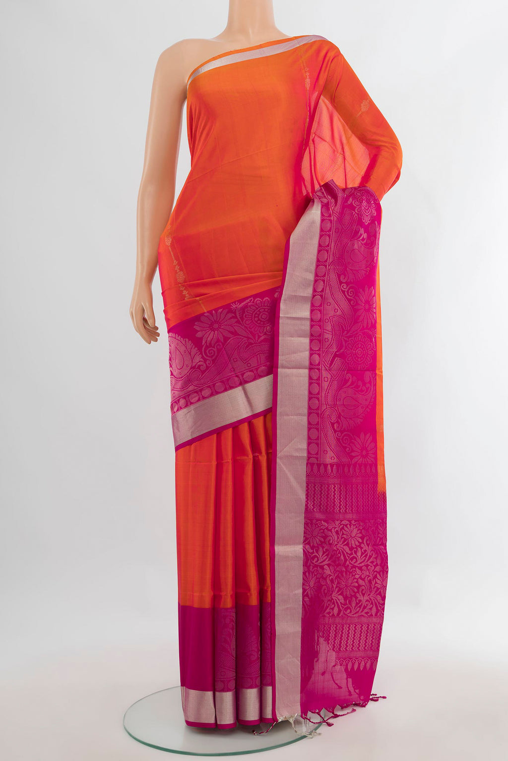 Pure Silk Orange Soft Saree with Zari Butta on the body and Fancy Border.  displayed on a mannequin
