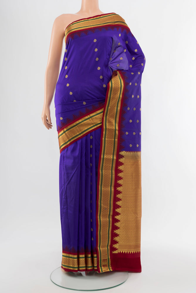 Pure Silk Pure Zari Dark Blue Kanchipuram Saree with Zari Butta on the body and Silk Border.  displayed on a mannequin