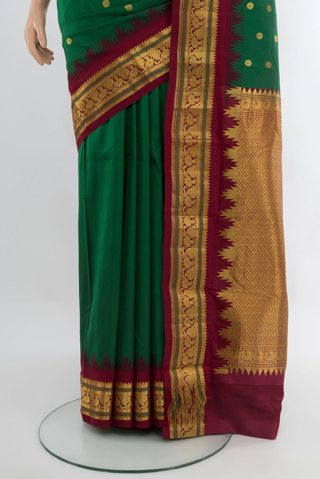 Pleats and pallu of Bottle Green Kanchipuram Silk Saree with Zari Butta on the body and Zari Border. 