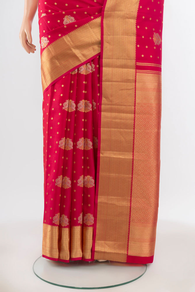 Pleats and pallu of Pure Silk Pure Zari Dark Pink Kanchipuram Saree with Zari Butta on the body and Silk Border. 