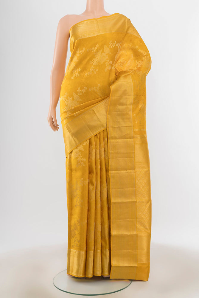 Yellow Kanjivaram Silk Saree with Zari Butta on the body and Silk Border.  displayed on a mannequin