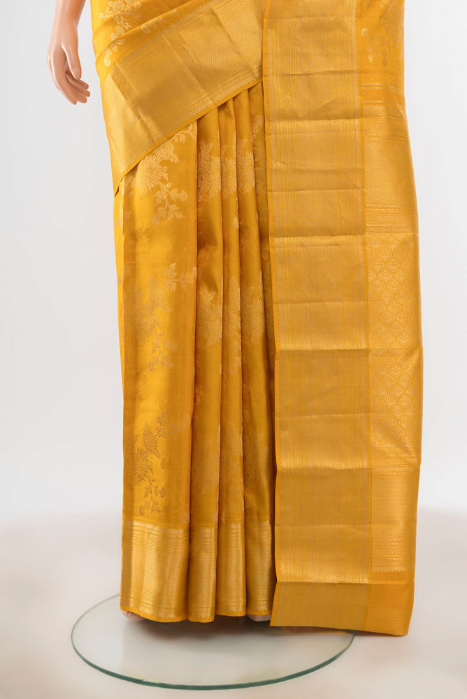 Pleats and pallu of Yellow Kanjivaram Silk Saree with Zari Butta on the body and Silk Border. 