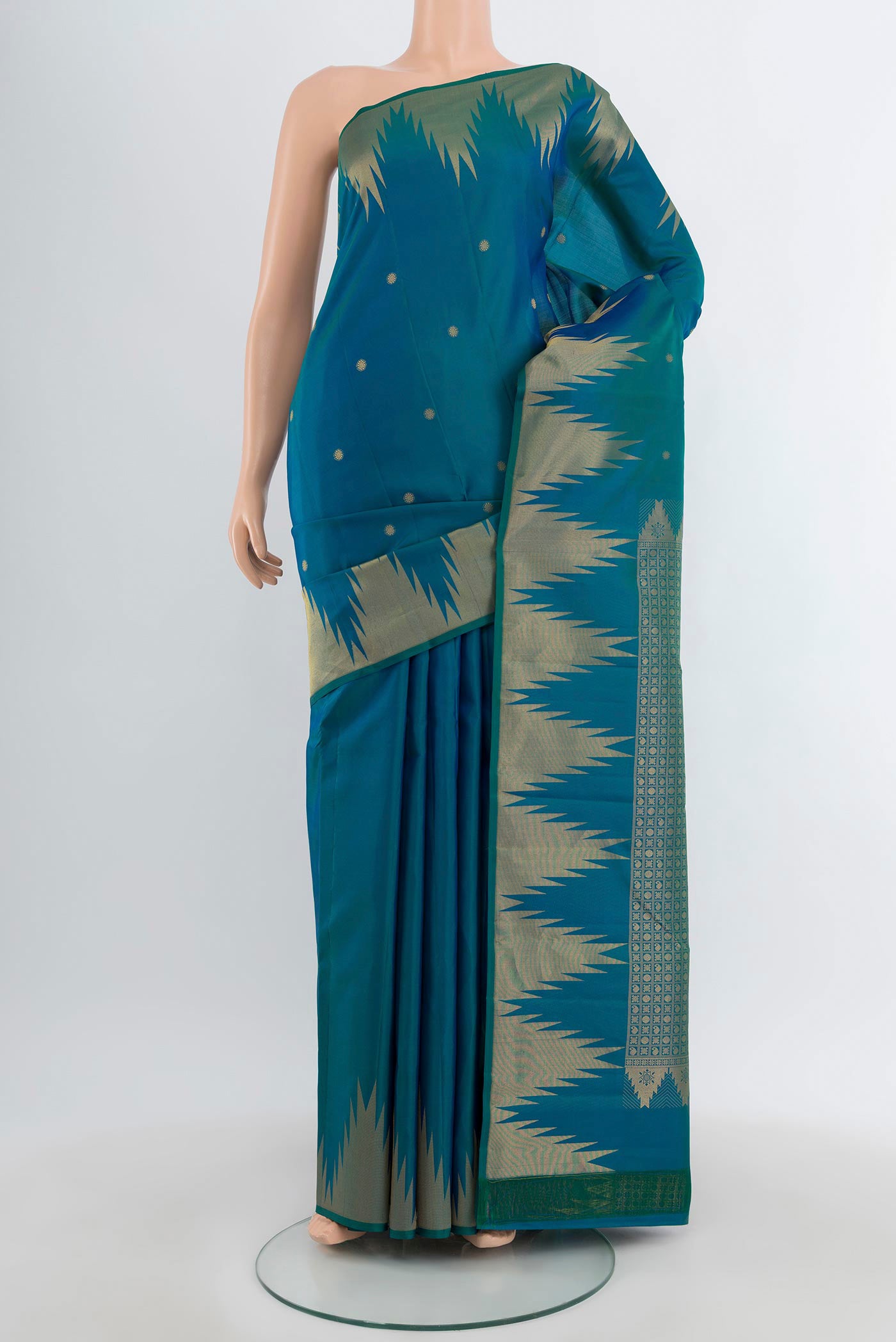 Peacock Blue Kanchipuram Silk Saree with Zari Butta on the body and Temple Border.  displayed on a mannequin
