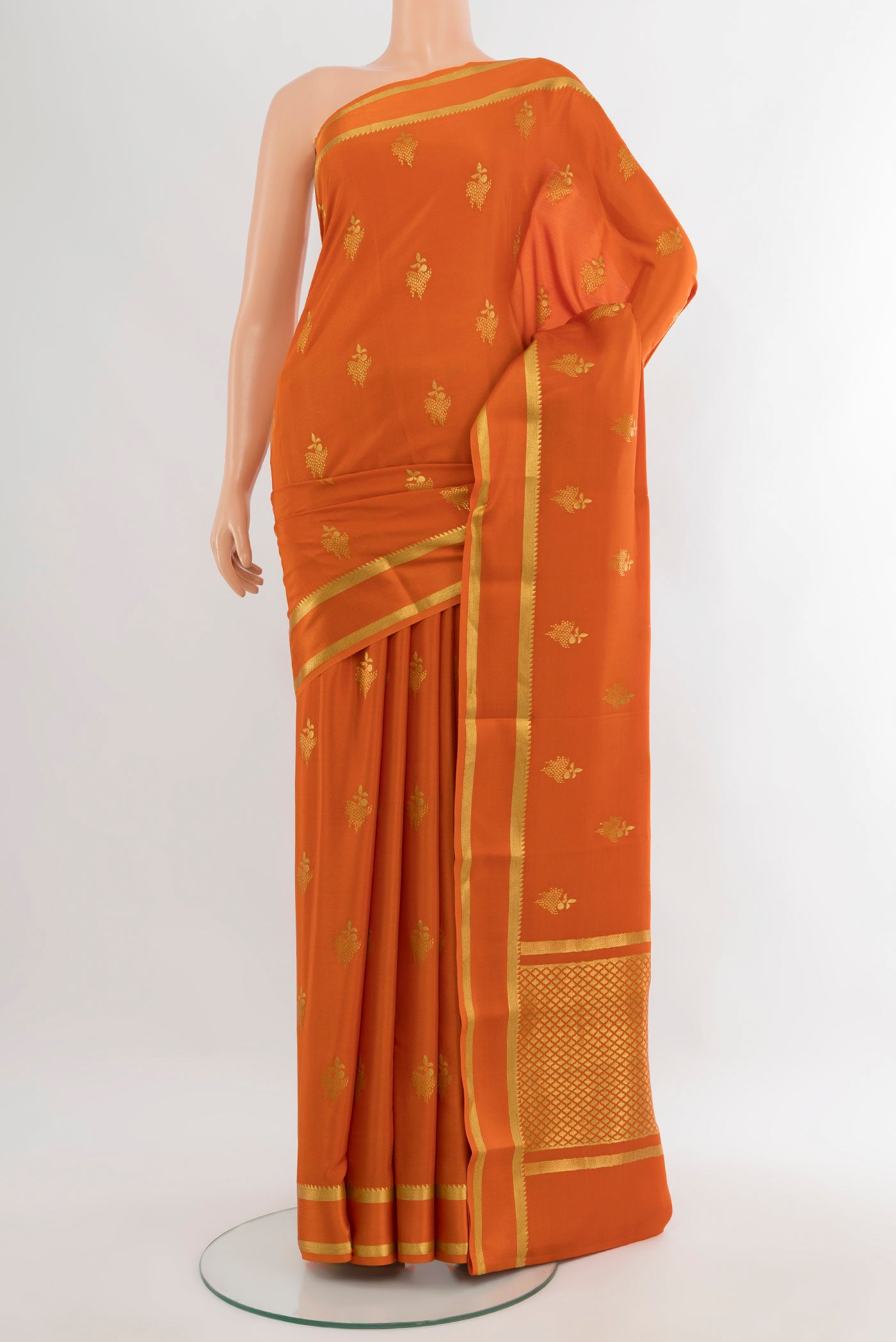 Rust Mysore Crepe Saree with Zari Butta on the body and Plain Border.  displayed on a mannequin
