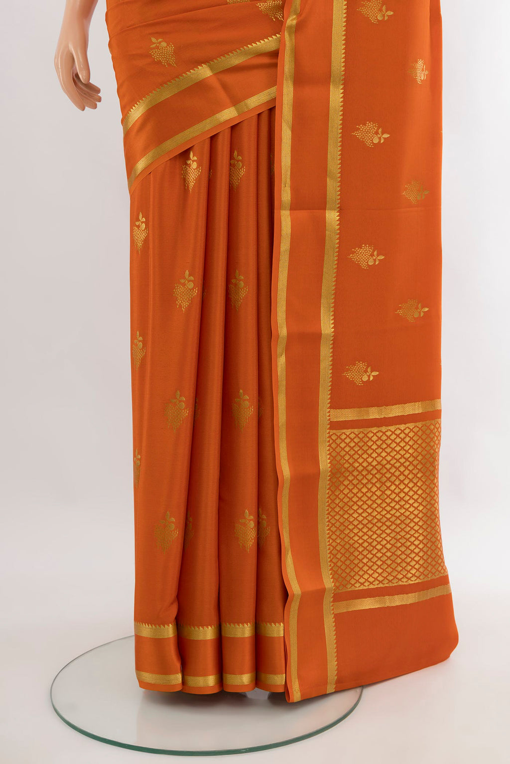 Pleats and pallu of Rust Mysore Crepe Saree with Zari Butta on the body and Plain Border. 