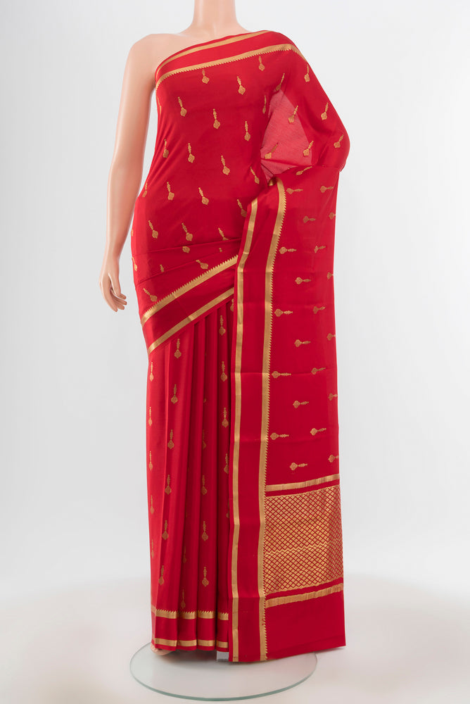 Pure Silk Pure Zari Red Mysore Crepe Saree with Zari Butta on the body and Silk Border.  displayed on a mannequin