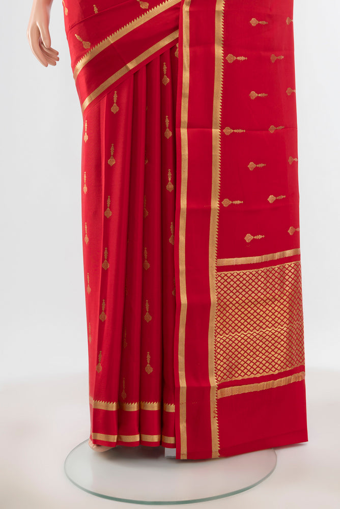 Pleats and pallu of Pure Silk Pure Zari Red Mysore Crepe Saree with Zari Butta on the body and Silk Border. 