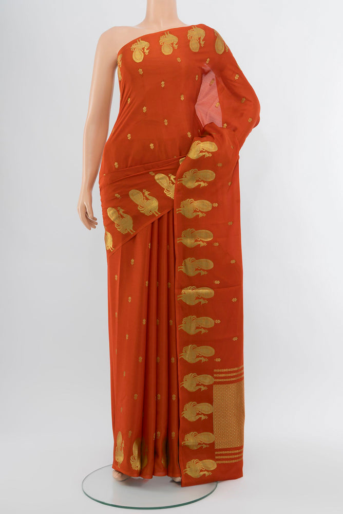 Brick Orange Mysore Crepe Saree with Zari Butta on the body and Zari Border.  displayed on a mannequin