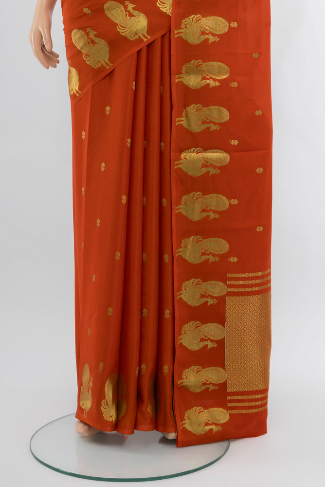Pleats and pallu of Brick Orange Mysore Crepe Saree with Zari Butta on the body and Zari Border. 