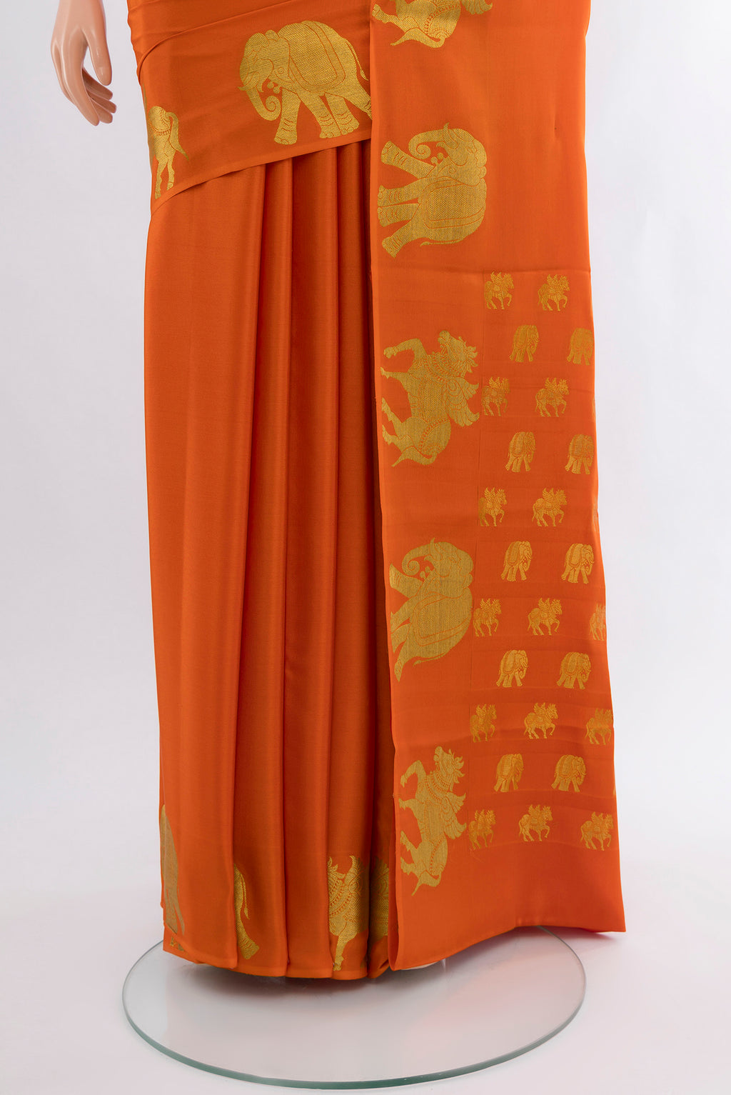 Pleats and pallu of Orange Mysore Crepe Saree with Plain Body and Zari Border. 