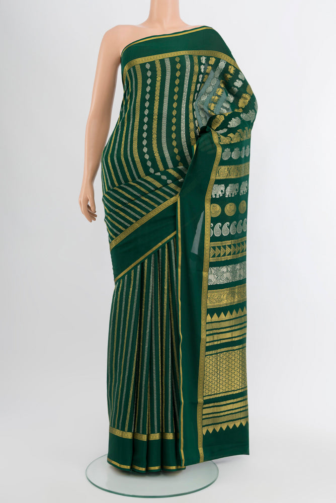 Bottle Green Mysore Crepe Saree with Zari Butta on the body and Silk Border.  displayed on a mannequin