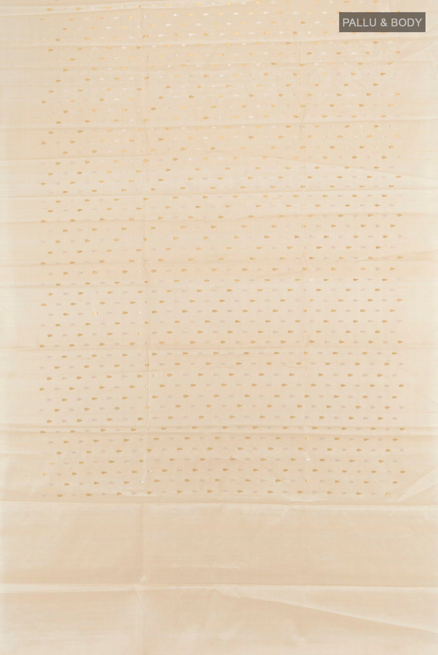 Flat view of Cream Tussar Silk Saree with Zari Butta on the body and Zari Border. 