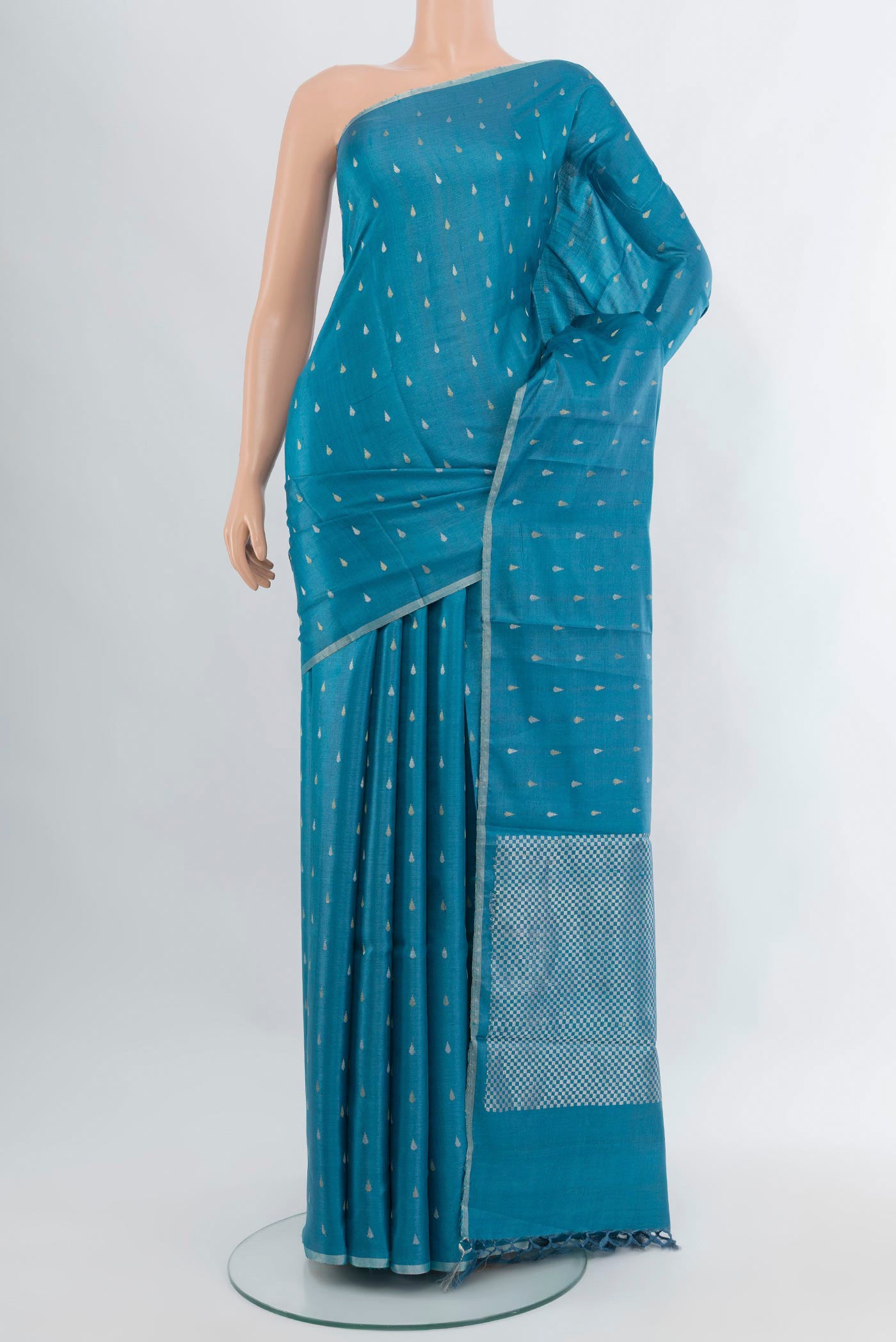 Sky Blue Tussar Silk Saree with Zari Butta on the body and Plain Border.  displayed on a mannequin
