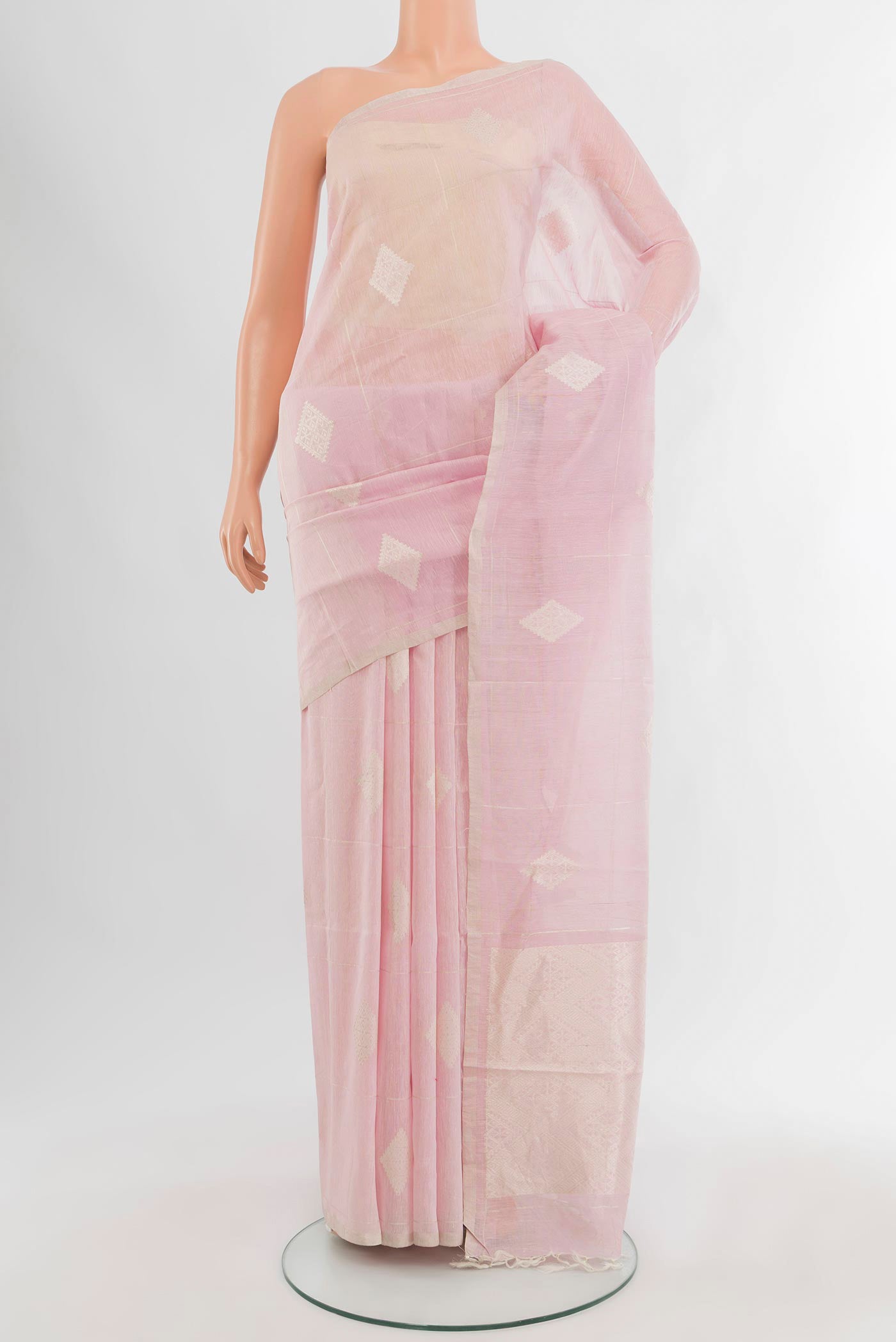 Rose pink Tussar Silk Saree with Zari Butta on the body and Zari Border.  displayed on a mannequin
