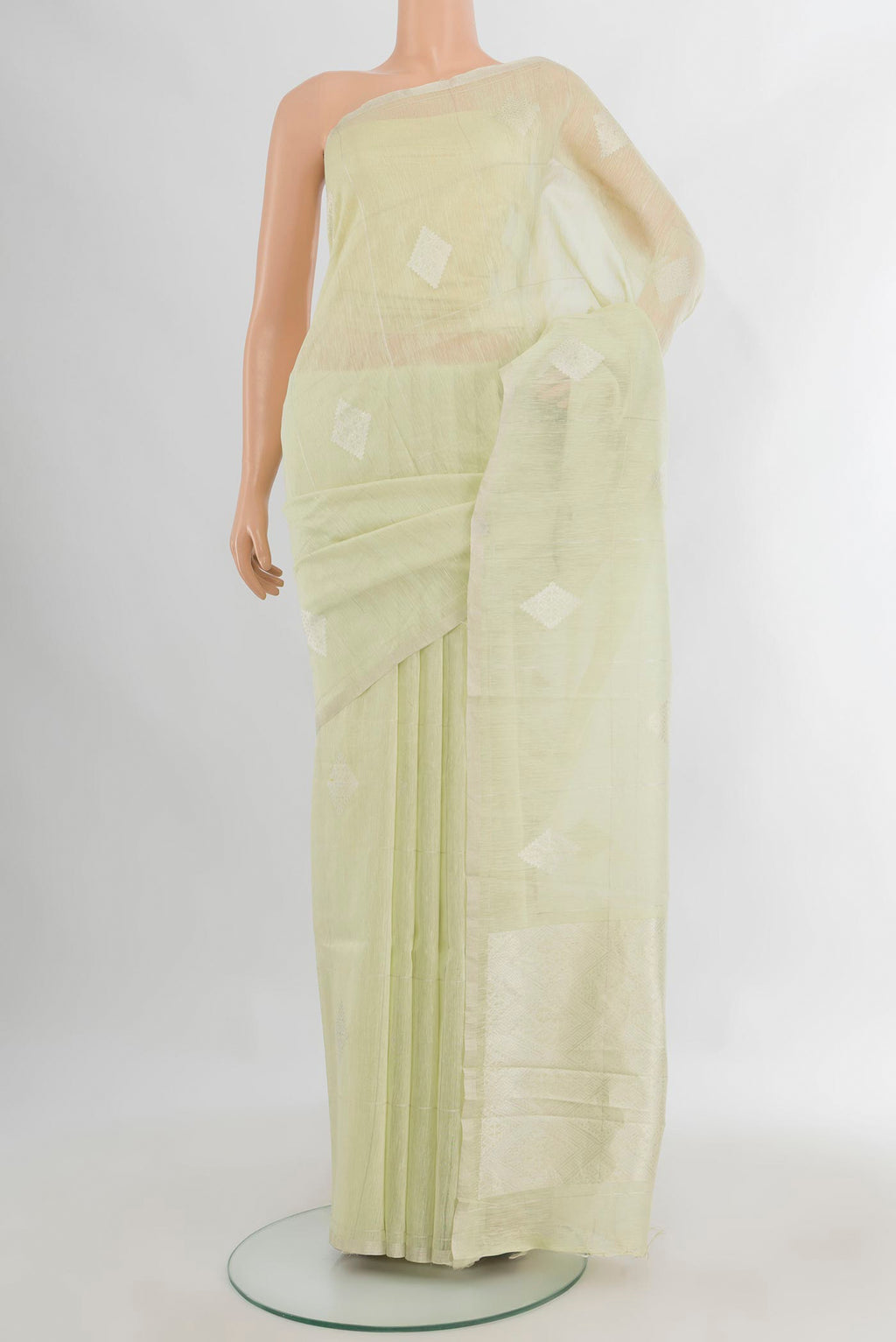 Pure Silk Light Green Tussar Saree with Thread Butta on the body and Plain Border.  displayed on a mannequin