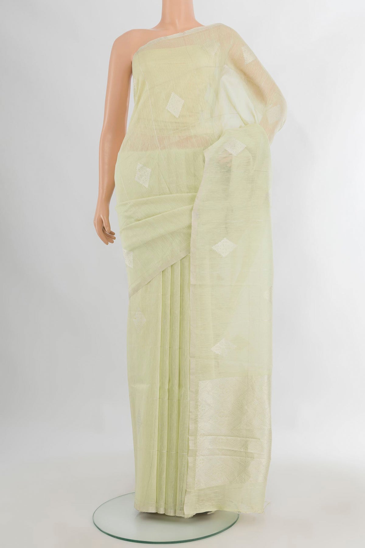 Pure Silk Light Green Tussar Saree with Thread Butta on the body and Plain Border.  displayed on a mannequin