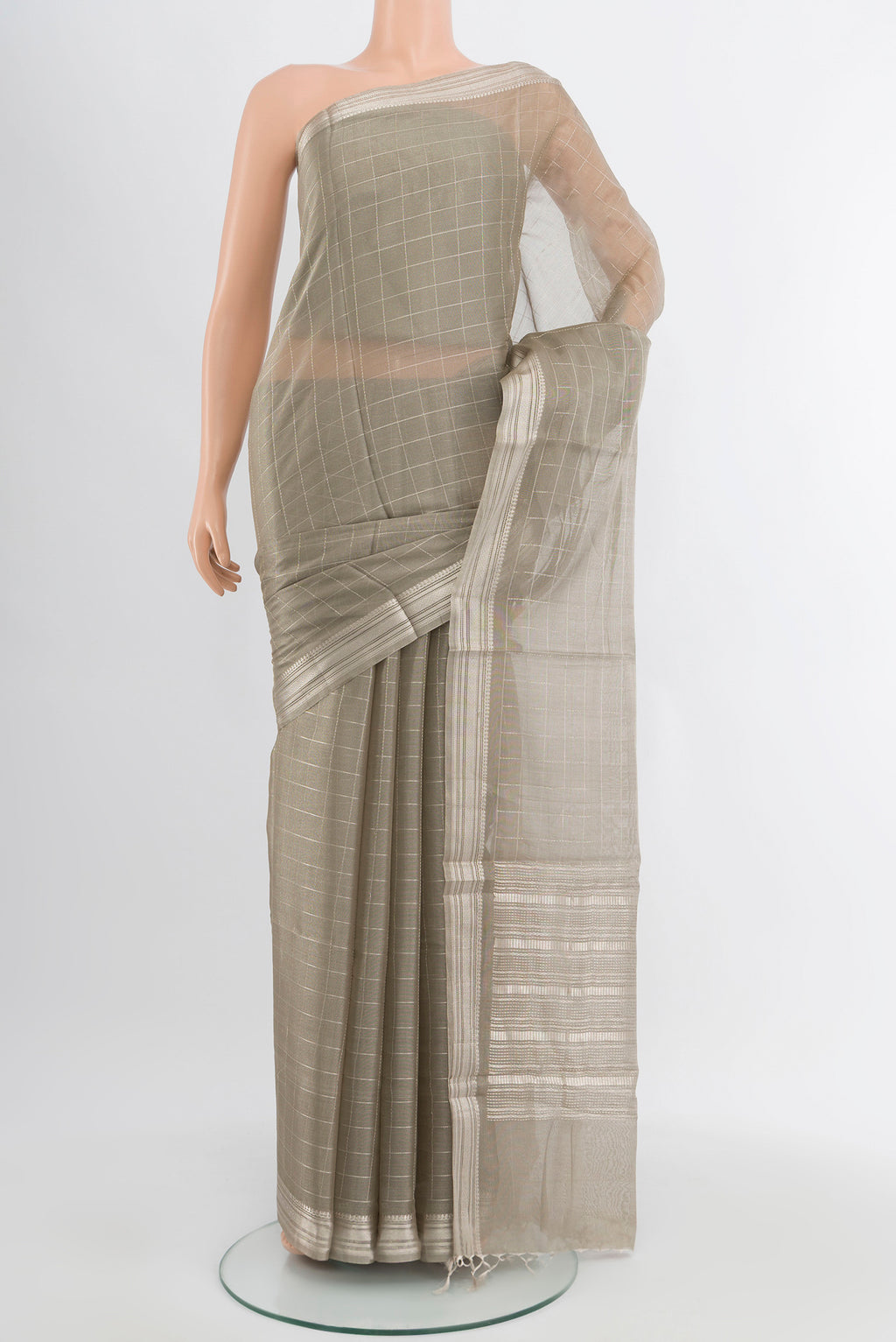 Grey Tussar Silk Saree with Zari Butta on the body and Silk Border.  displayed on a mannequin