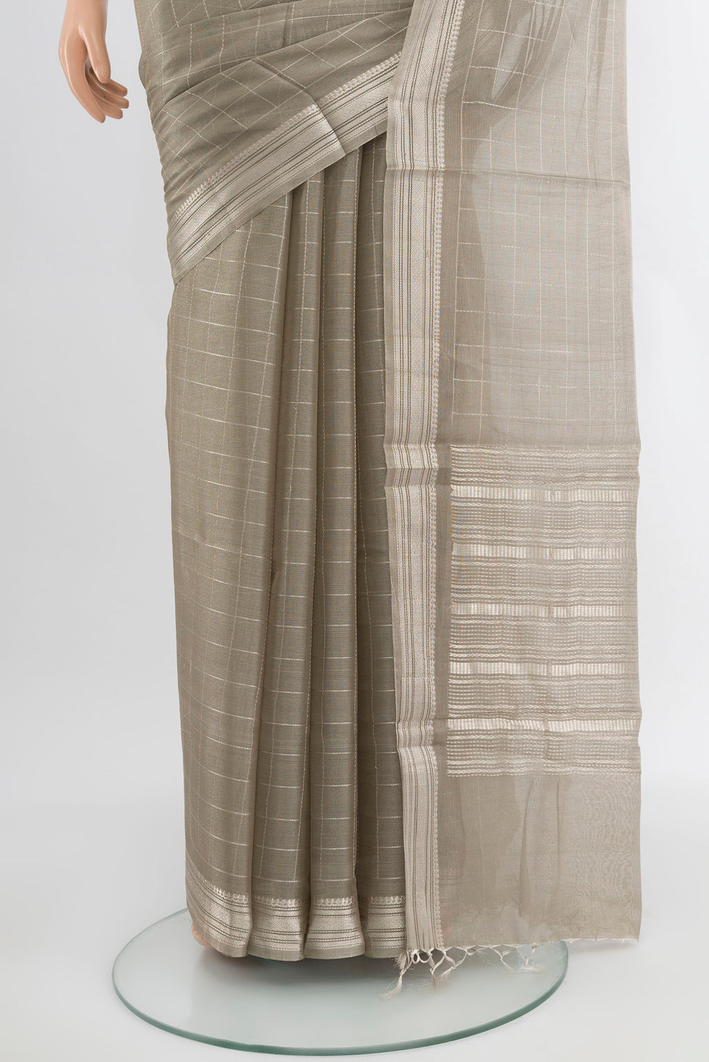 Pleats and pallu of Grey Tussar Silk Saree with Zari Butta on the body and Silk Border. 