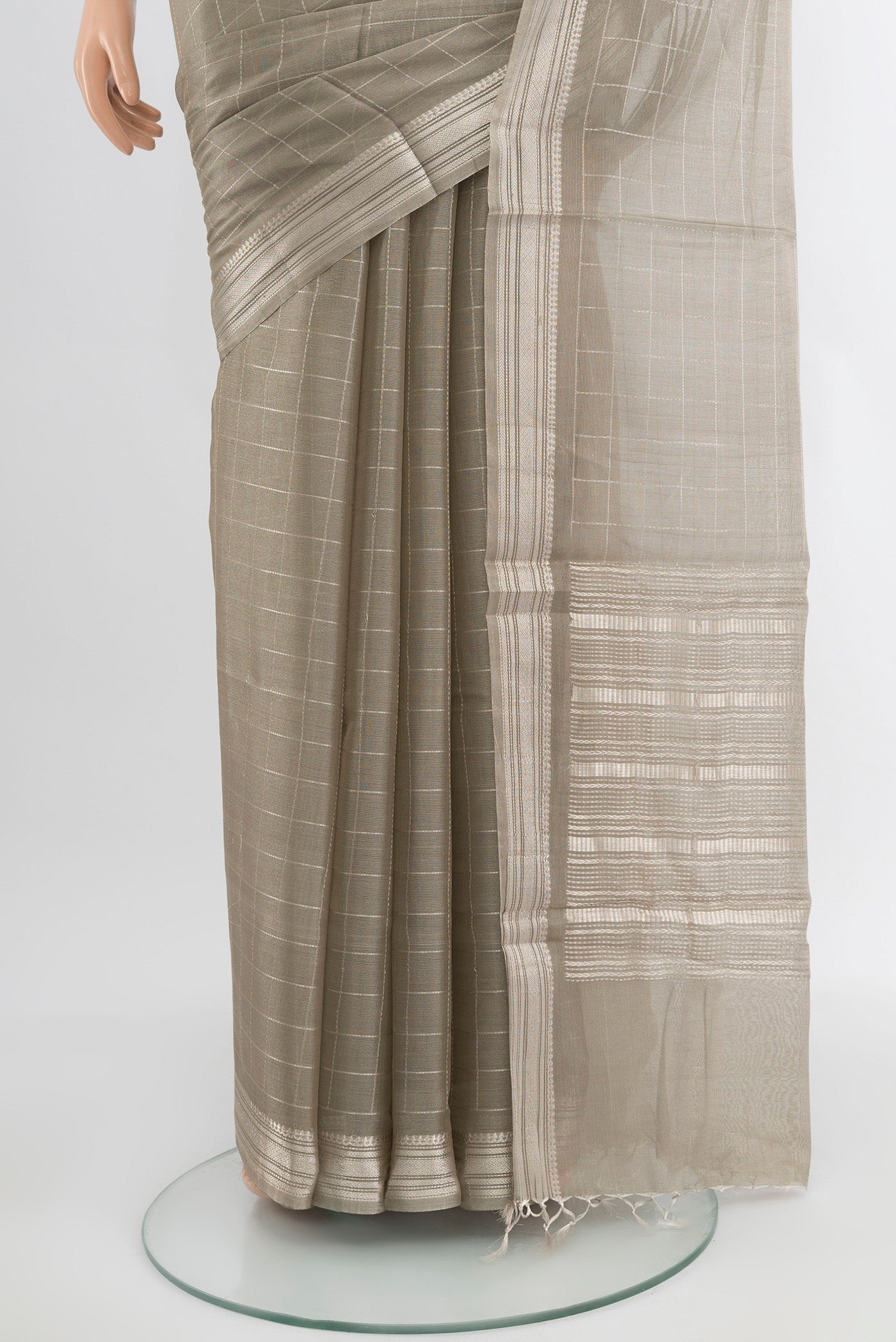 Pleats and pallu of Grey Tussar Silk Saree with Zari Butta on the body and Silk Border. 