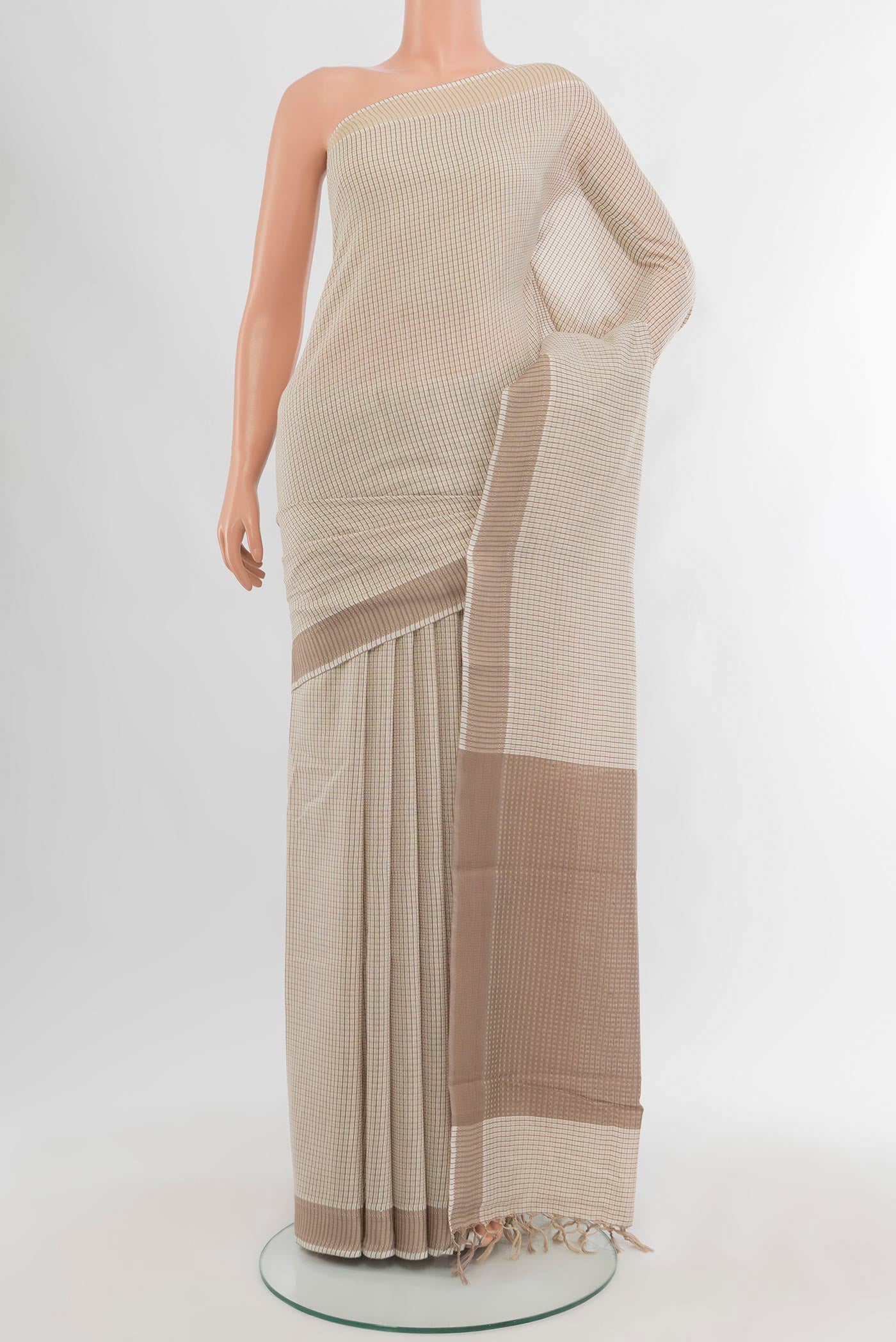 Off White Tussar Silk Saree with Checked design on the body and Zari Border.  displayed on a mannequin