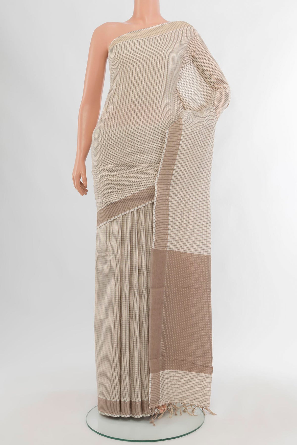Off White Tussar Silk Saree with Checked design on the body and Zari Border.  displayed on a mannequin