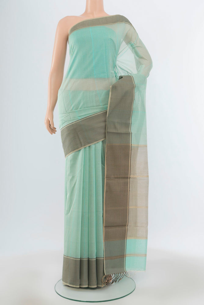 Light Green Maheshwari Silk Cotton Saree with Plain Body and Silk Border.  displayed on a mannequin