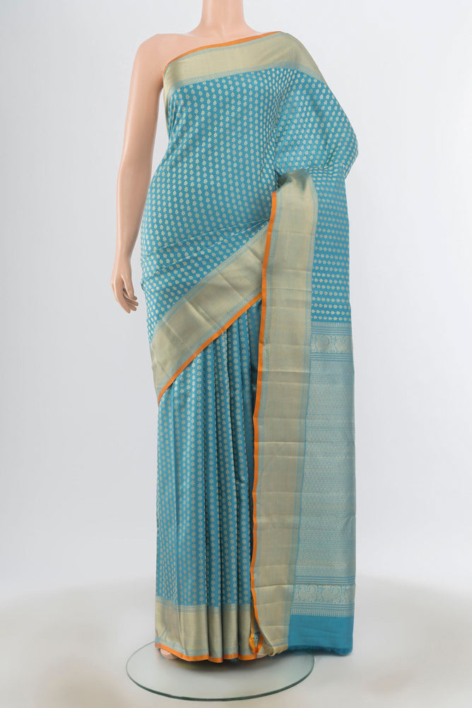 Light Blue Kanchipuram Silk Saree with Zari Butta on the body and Silk Border.  displayed on a mannequin