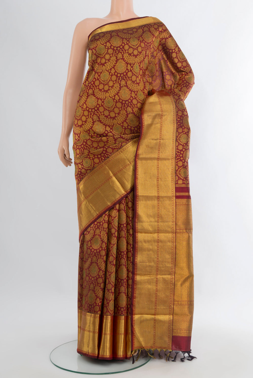 Maroon Kanchipuram Silk Saree with Zari Brocade on the body and Zari Border.  displayed on a mannequin