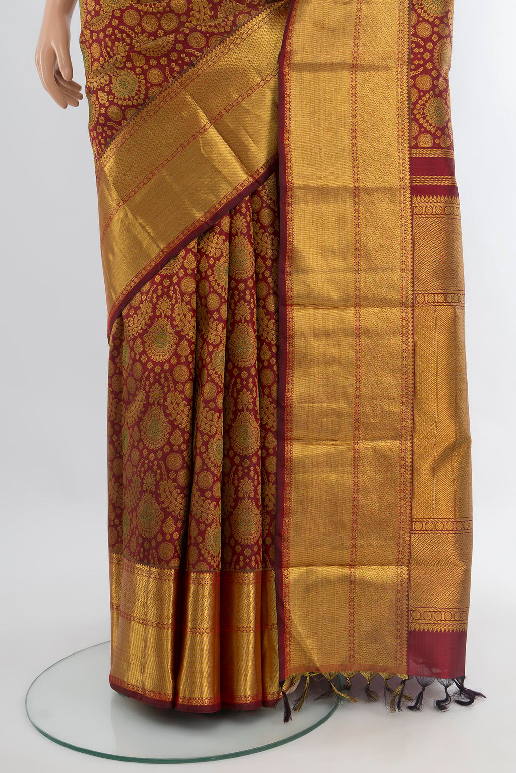 Pleats and pallu of Maroon Kanchipuram Silk Saree with Zari Brocade on the body and Zari Border. 