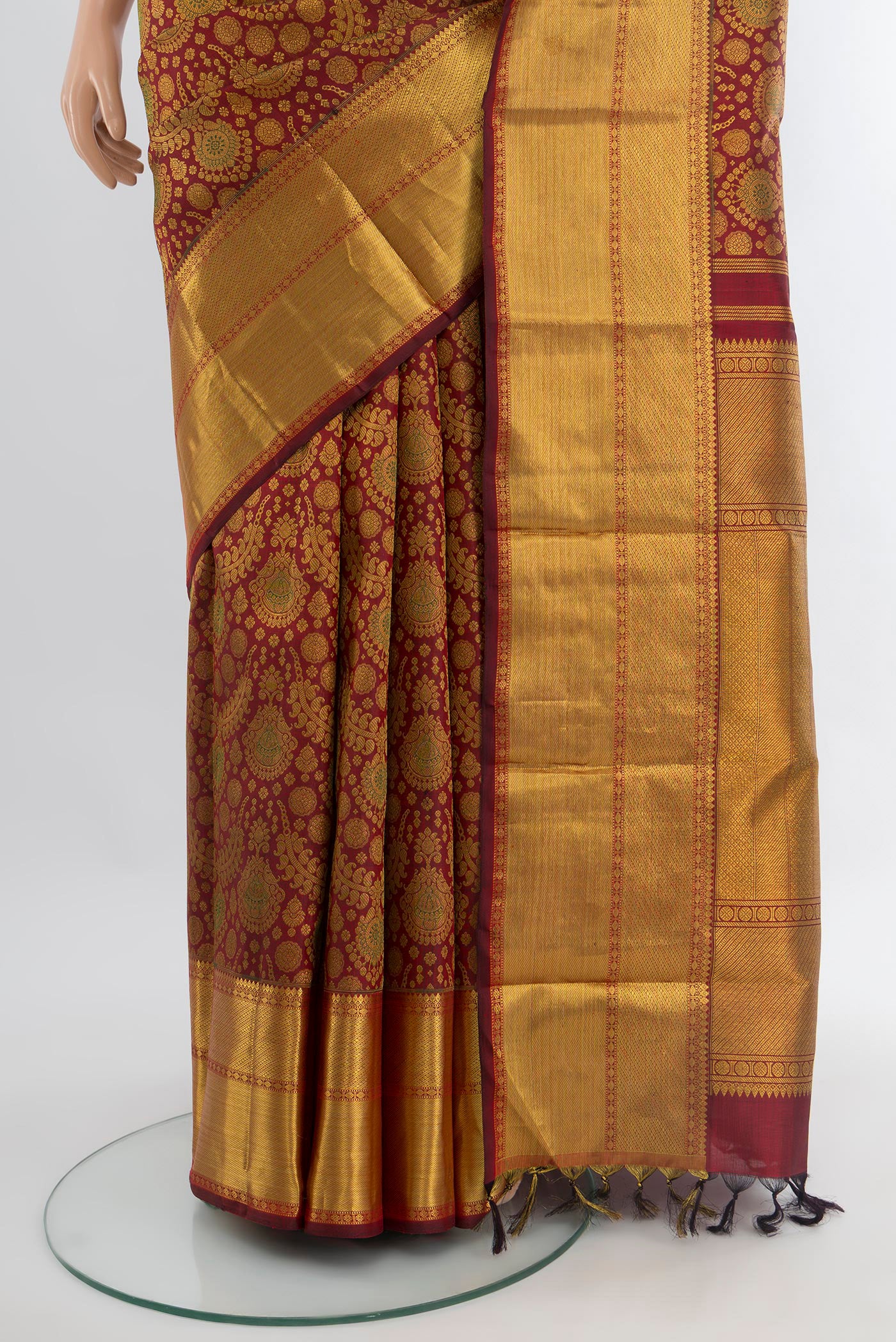 Pleats and pallu of Maroon Kanchipuram Silk Saree with Zari Brocade on the body and Zari Border. 