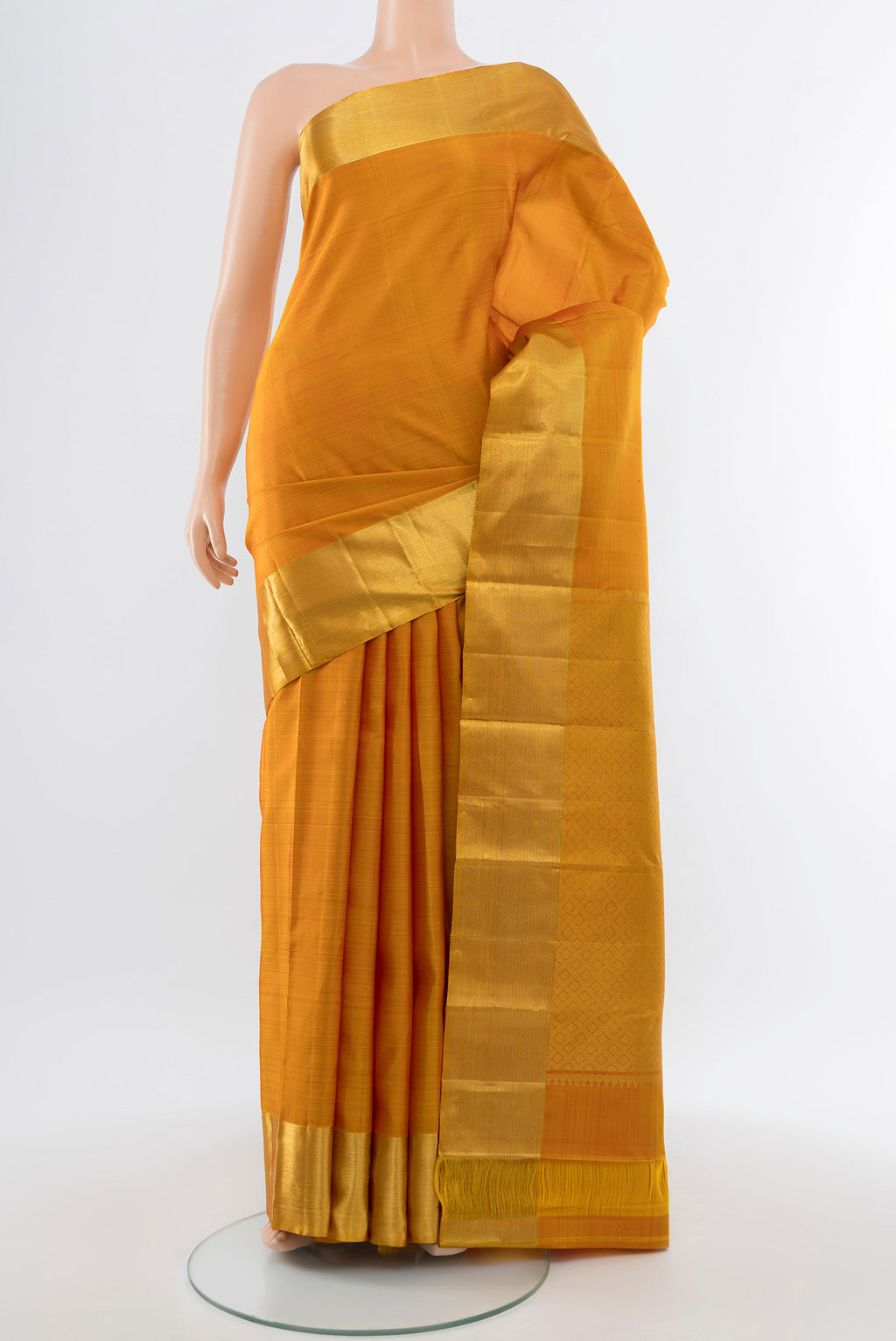 Mustard Kanjivaram Silk Saree with Zari Butta on the body and Silk Border.  displayed on a mannequin