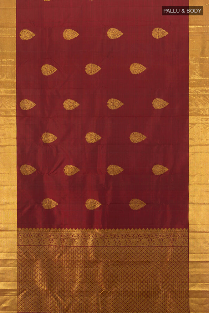 Flat view of Pure Silk Pure Zari Maroon Kanchipuram Saree with Zari Butta on the body and Silk Border. 