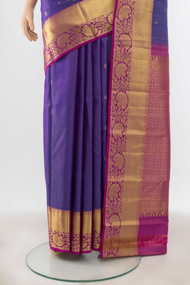Pleats and pallu of Violet Kanchipuram Silk Saree with Zari Butta on the body and Silk Border. 