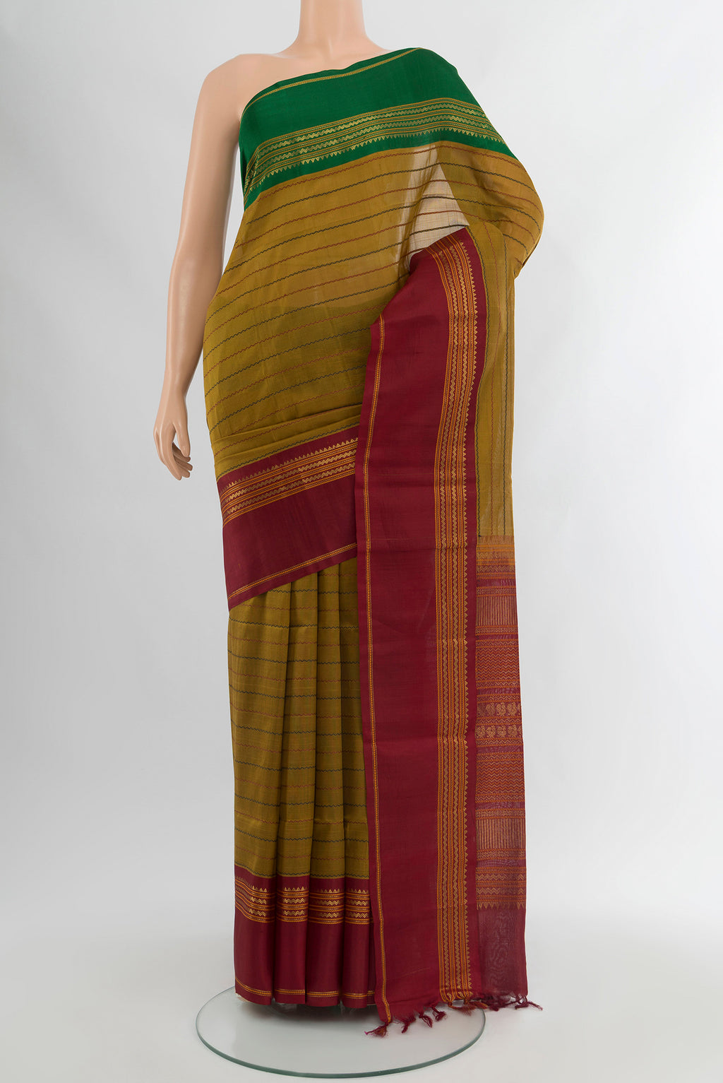 Mehandi Green Silk Cotton Saree with Veldhari on the body and Zari Border.  displayed on a mannequin
