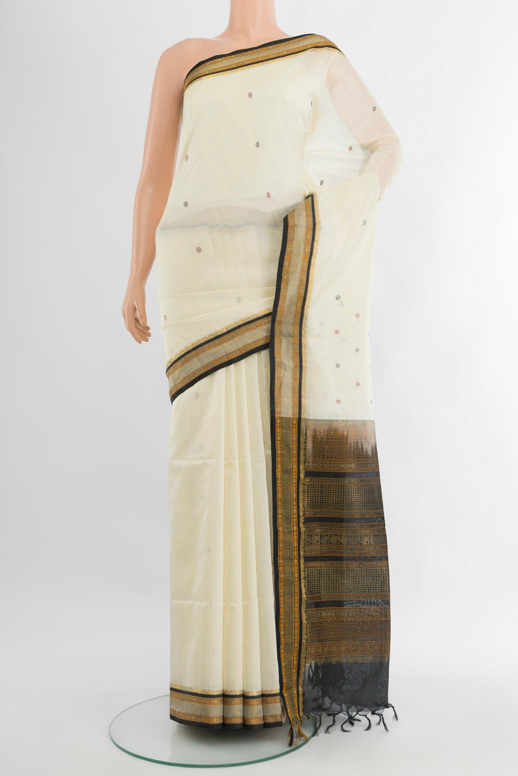 Off White Silk Cotton Saree with Thread Butta on the body and Zari Border.  displayed on a mannequin