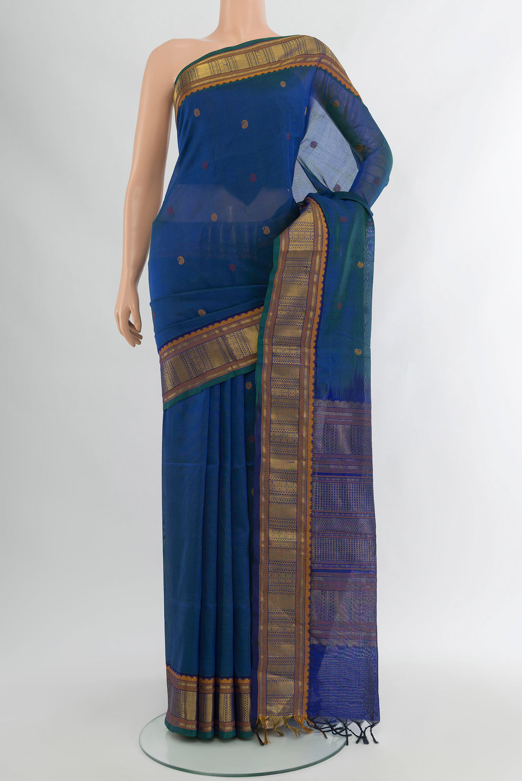 Peacock Blue Silk Cotton Saree with Thread Butta on the body and Zari Border.  displayed on a mannequin