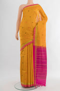 Mustard Silk Cotton Saree with Stripes on the body and Zari Border.  displayed on a mannequin