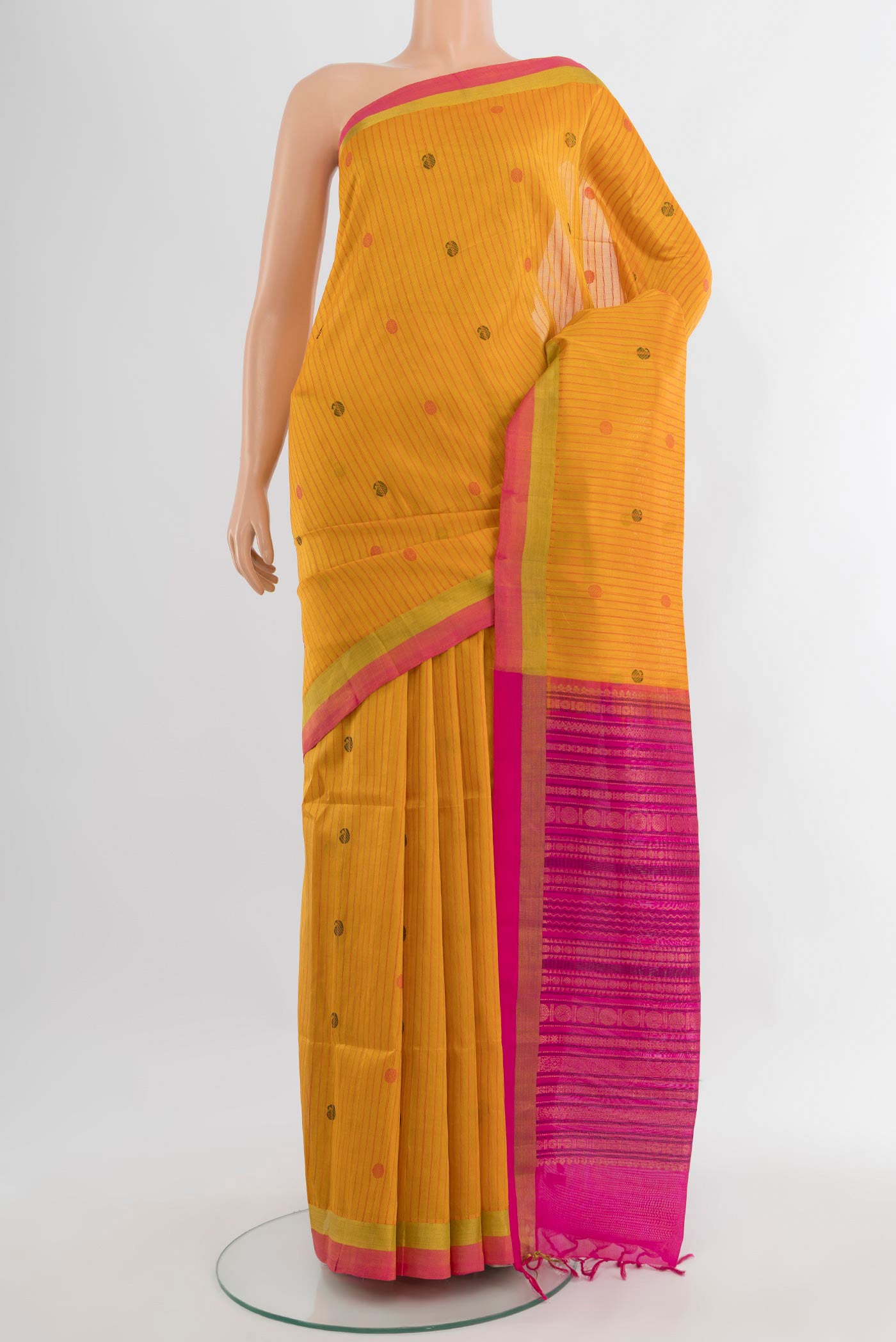 Mustard Silk Cotton Saree with Stripes on the body and Zari Border.  displayed on a mannequin
