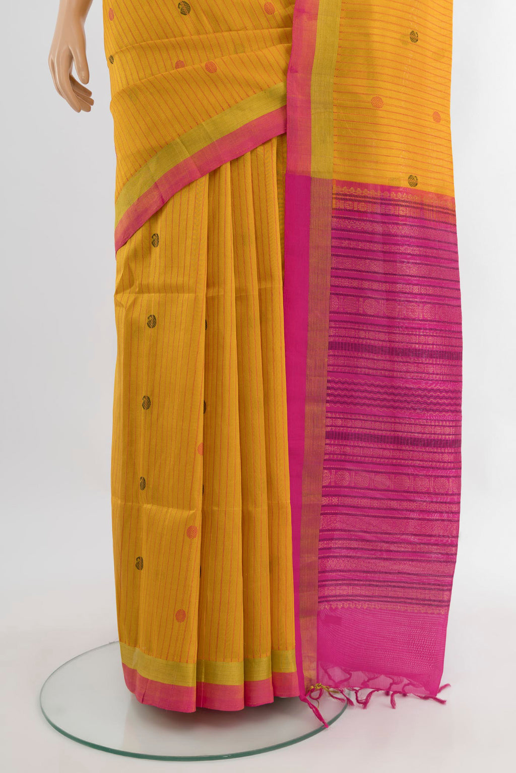 Pleats and pallu of Mustard Silk Cotton Saree with Stripes on the body and Zari Border. 