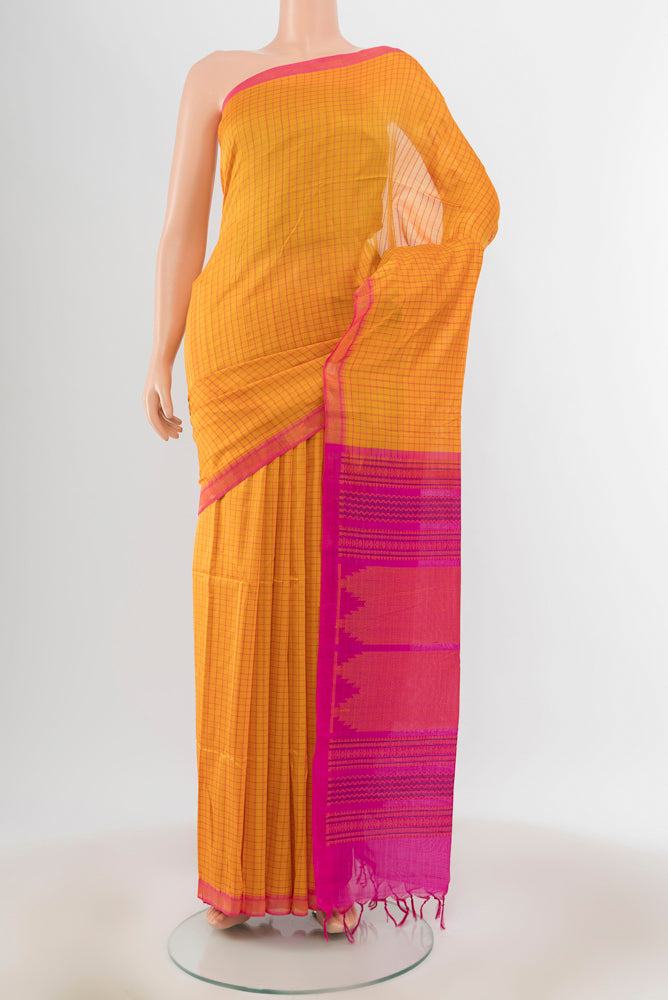 Yellow Silk Cotton Saree with Zari Butta on the body and Silk Border.  displayed on a mannequin