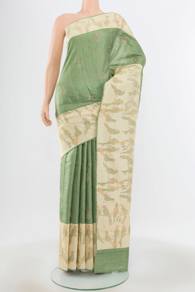 Pure Silk Pure Zari Light Green Tussar Saree with Zari Butta on the body and Silk Border.  displayed on a mannequin