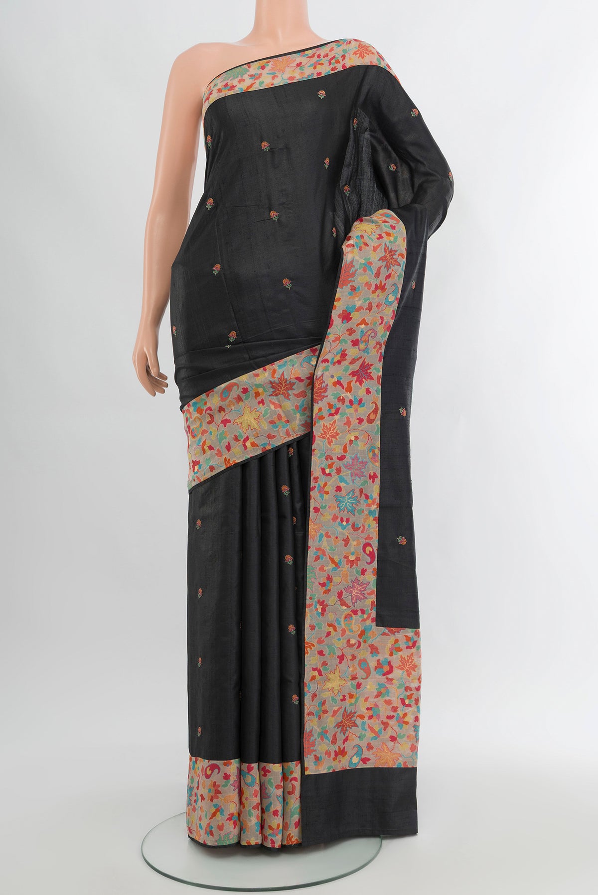 Black Tussar Silk Saree with Embroidery on the body and Attached Border.  displayed on a mannequin