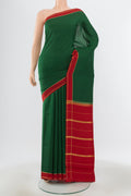 Pure Silk Pure Zari Bottle Green Mysore Crepe Saree with Zari Butta on the body and Silk Border.  displayed on a mannequin